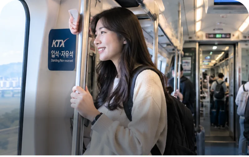 Passenger holding a rail in the KTX standing-seat area